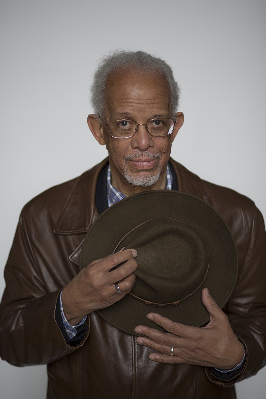 Maurice Eldridge, an older man, holds his hat against his chest.